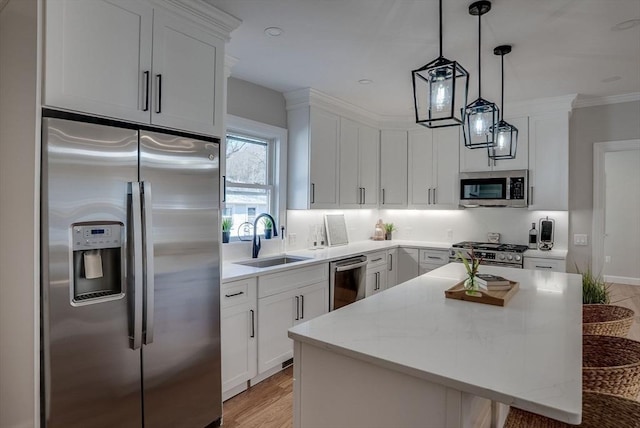 kitchen featuring stainless steel appliances, white cabinetry, and a sink