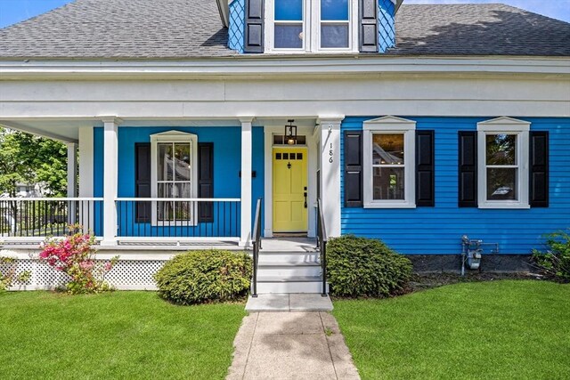 186 Chapel St, Abington, MA 02351 - doorway to property with roof with shingles, covered porch, and a yard