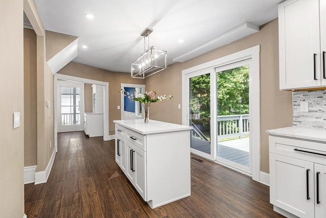 186 Chapel St, Abington, MA 02351 - kitchen with healthy amount of natural light, dark wood-type flooring, white cabinetry, baseboards, and recessed lighting