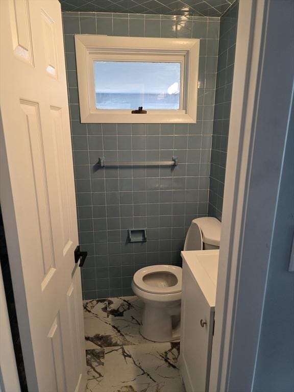 32 Central Ave, Everett, MA 02149 - bathroom with marble finish flooring, vanity, toilet, and tile walls