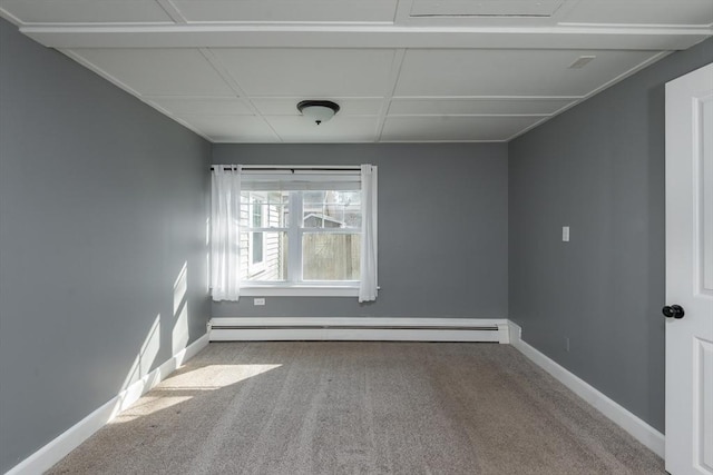 carpeted empty room with baseboard heating and baseboards