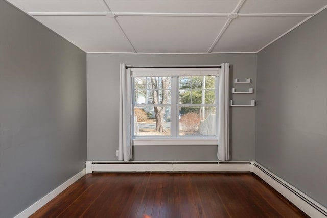 unfurnished room featuring a baseboard radiator, dark wood-style flooring, and baseboards