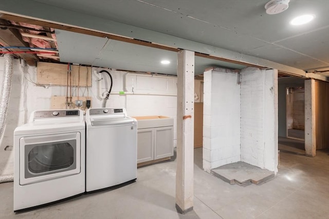 washroom with cabinet space and washer and clothes dryer