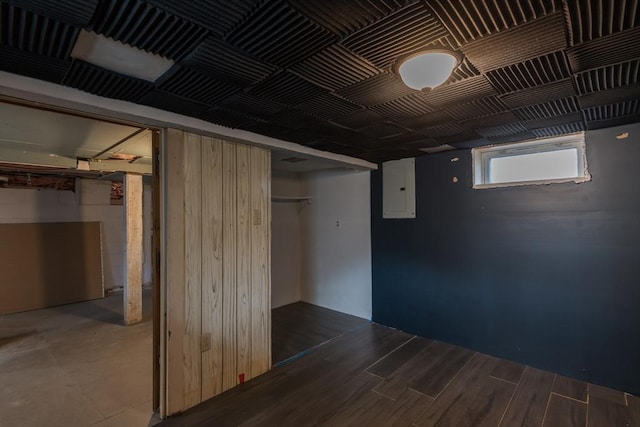 basement featuring electric panel and wood finished floors