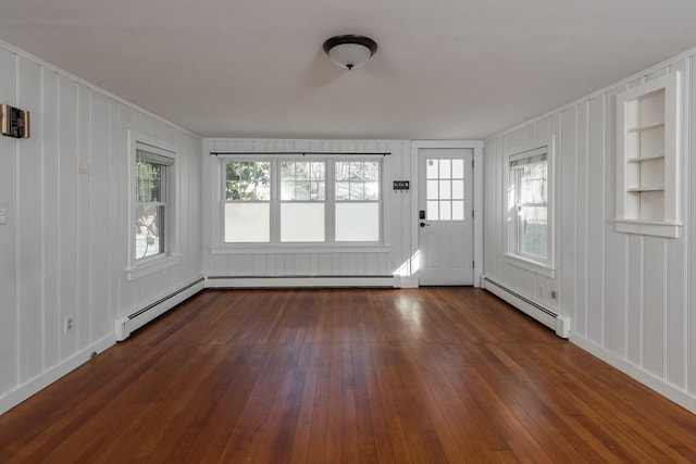 unfurnished sunroom featuring a baseboard heating unit