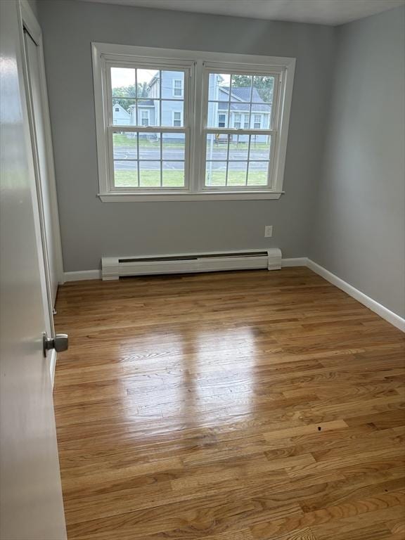 945 Shoemaker Ln, Agawam, MA 01030 - unfurnished room featuring a baseboard radiator and wood finished floors