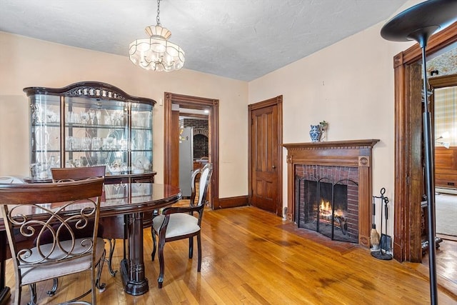 14 Franklin Ter, Boston, MA 02136 - dining area with hardwood / wood-style flooring, a chandelier, a fireplace, and a textured ceiling