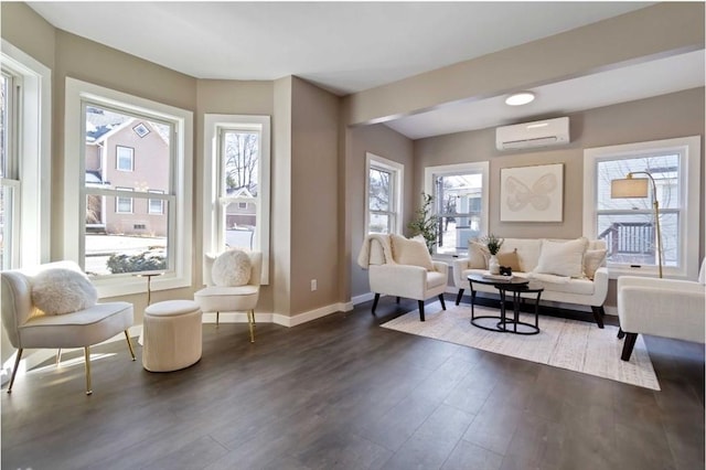 sitting room with dark wood-type flooring and an AC wall unit