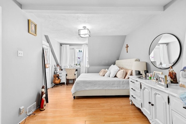 bedroom featuring visible vents and light wood-style flooring