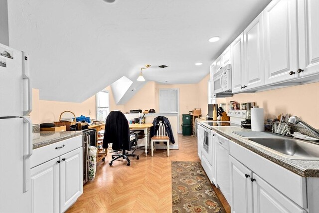 kitchen with lofted ceiling, white cabinets, a sink, recessed lighting, and white appliances