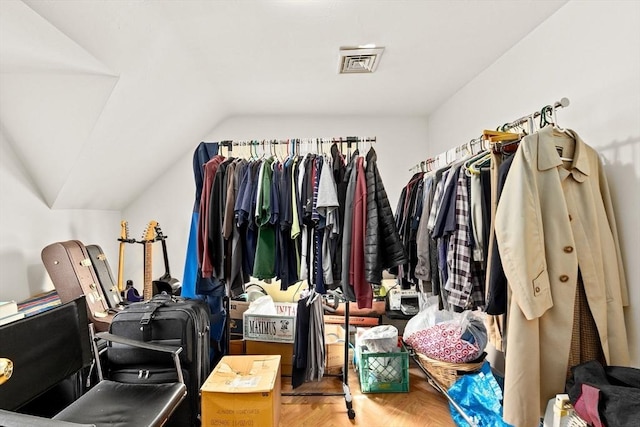 walk in closet featuring visible vents and vaulted ceiling