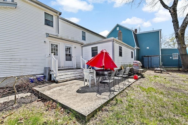 back of property with a patio and fence