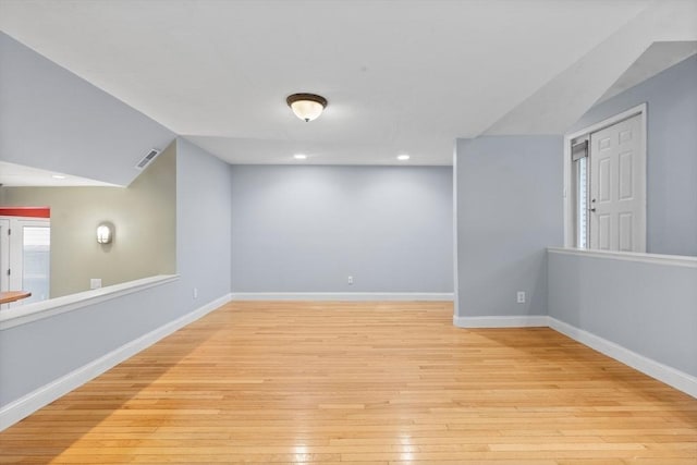 interior space featuring a healthy amount of sunlight, light hardwood / wood-style floors, and lofted ceiling