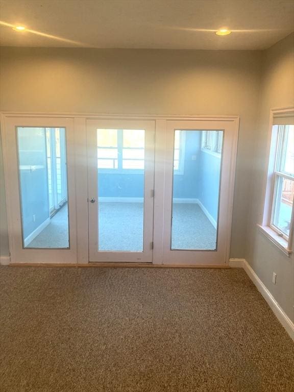 entryway with french doors and carpet floors