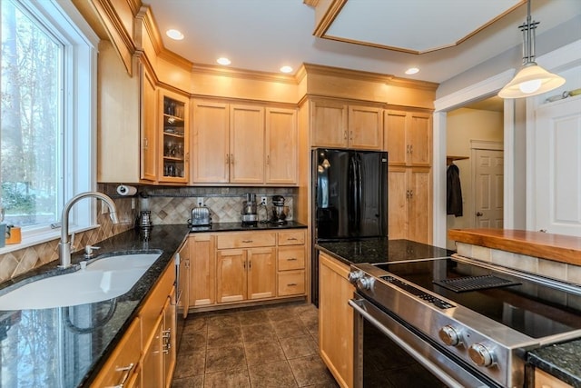 kitchen with black refrigerator, electric stove, sink, tasteful backsplash, and dark stone counters