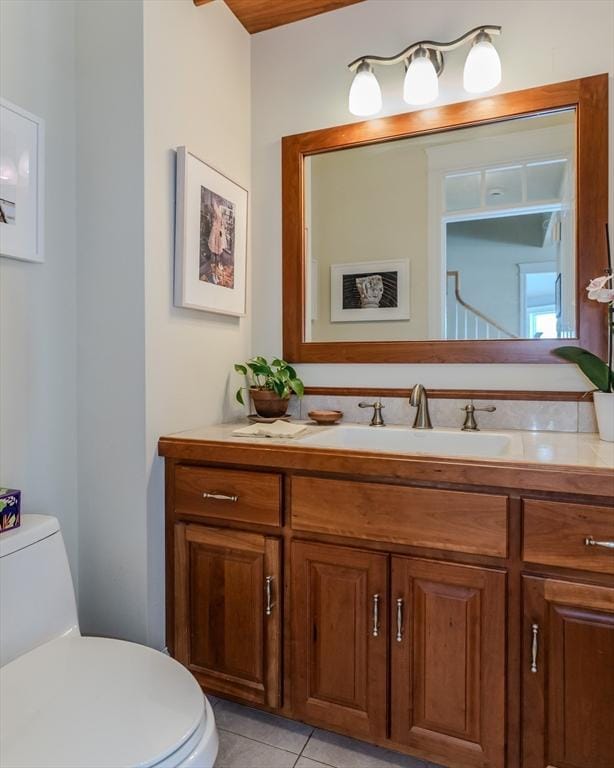 bathroom with tile patterned floors, toilet, and vanity