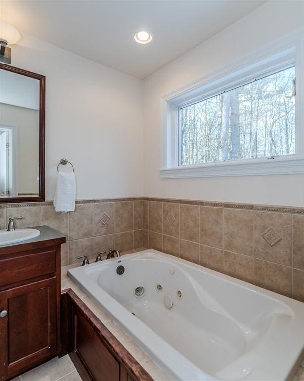 bathroom with vanity, a tub, and tile patterned floors