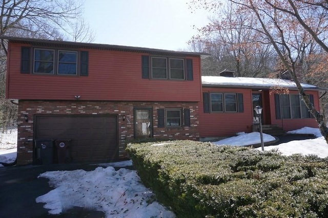 split level home with a garage and a chimney