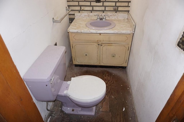 bathroom featuring toilet and vanity