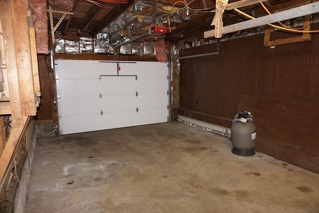 garage with wooden walls and a garage door opener