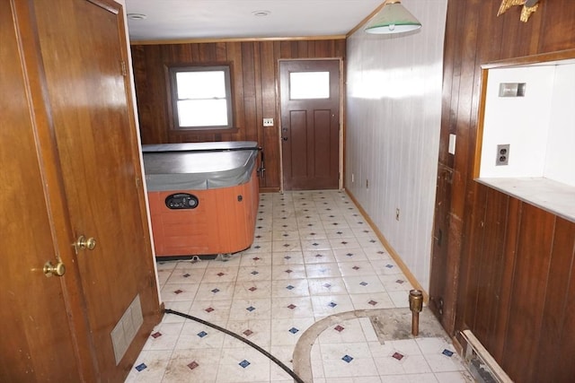 interior space with light floors, visible vents, and wood walls