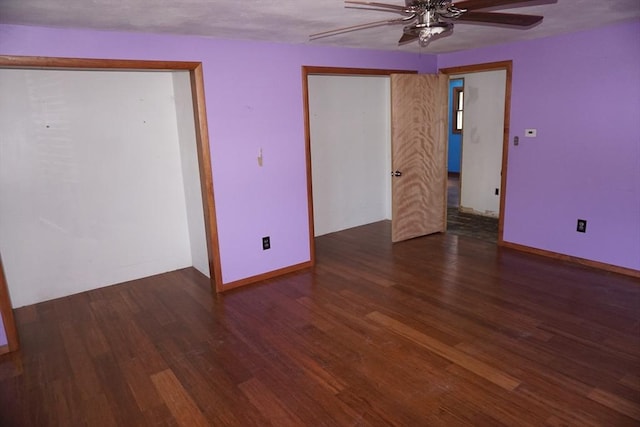 empty room with baseboards, wood finished floors, and a ceiling fan