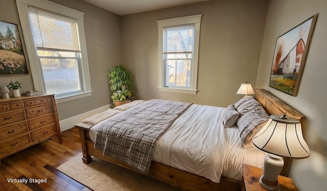 bedroom featuring wood-type flooring and multiple windows