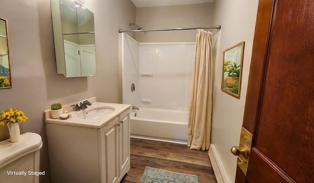 full bathroom featuring toilet, vanity, shower / tub combo, wood-type flooring, and baseboard heating