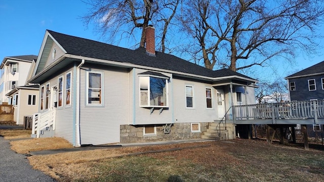 back of property with a wooden deck