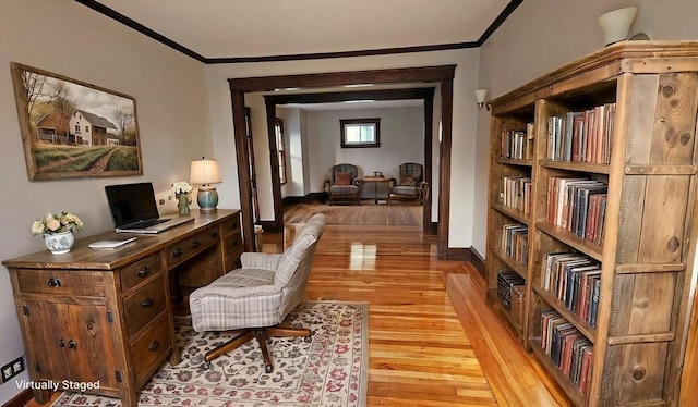 sitting room featuring crown molding and light hardwood / wood-style flooring