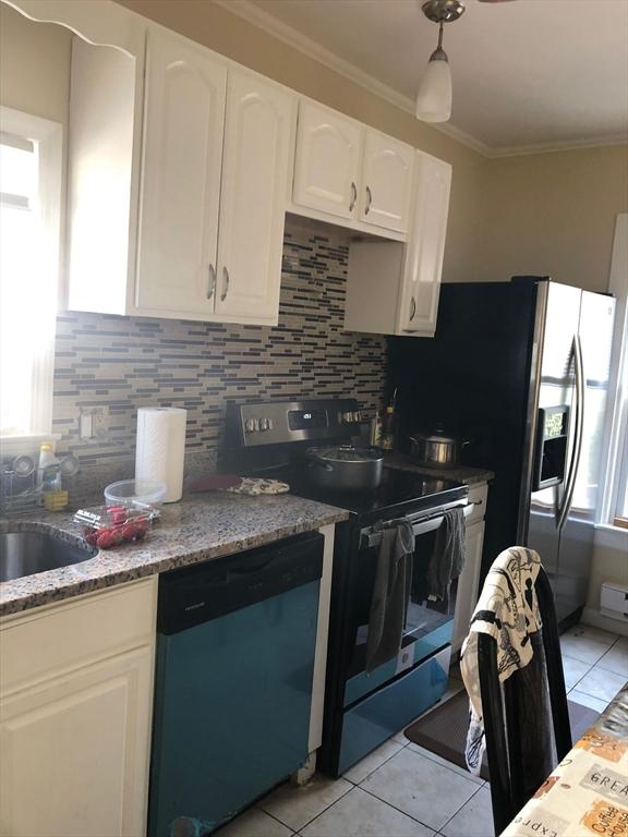 kitchen featuring dishwashing machine, backsplash, crown molding, and electric stove