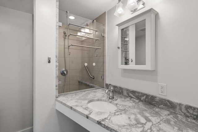 full bath featuring a stall shower and vanity