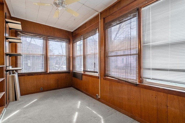 unfurnished sunroom with ceiling fan