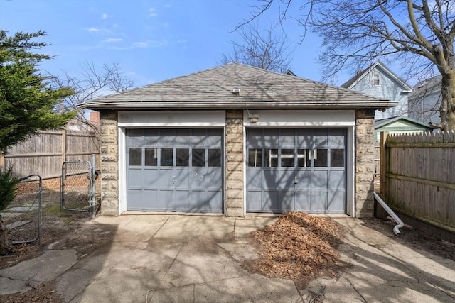 detached garage featuring fence