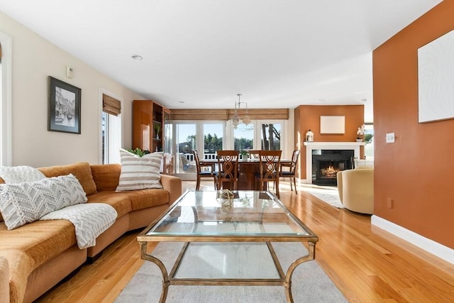 18 Hawkswood Ests Unit 18, Amesbury, MA 01913 - living room featuring light wood-style floors, baseboards, and a lit fireplace