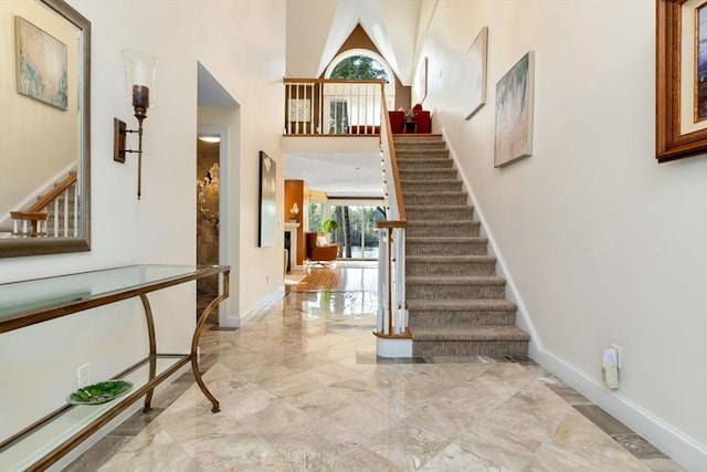 18 Hawkswood Ests Unit 18, Amesbury, MA 01913 - entrance foyer with marble finish floor, a wealth of natural light, stairs, and a high ceiling