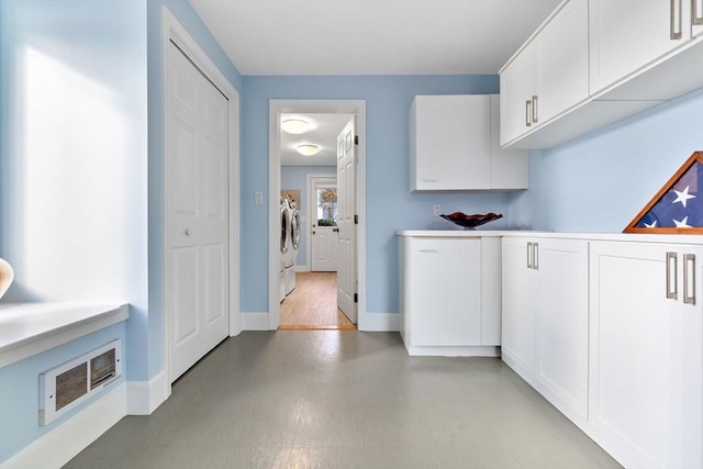 18 Hawkswood Ests Unit 18, Amesbury, MA 01913 - clothes washing area featuring separate washer and dryer, baseboards, laundry area, and visible vents