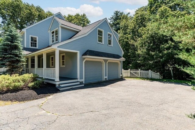 12 Coombs Cir, Newburyport, MA 01950 - view of front of home with a porch, asphalt driveway, a shingled roof, and an attached garage