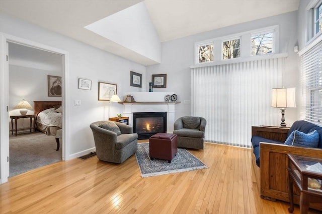 living area with hardwood / wood-style flooring and lofted ceiling