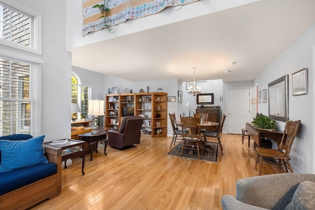 living room with light hardwood / wood-style flooring and a notable chandelier