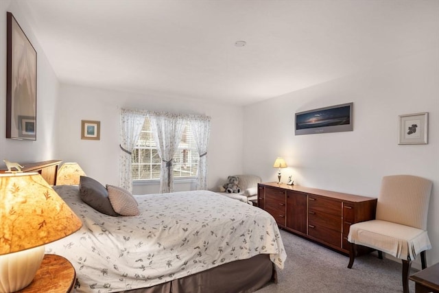 bedroom featuring light carpet