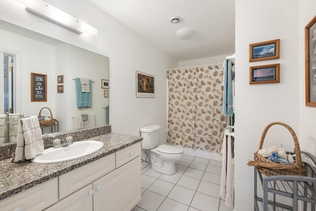 bathroom featuring tile patterned flooring, vanity, a shower with shower curtain, and toilet