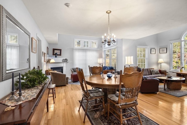 dining area with a notable chandelier and light hardwood / wood-style flooring