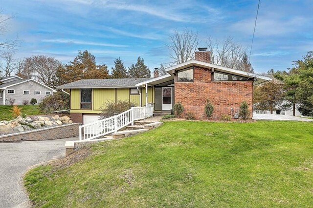 622 Pike Ave, Attleboro, MA 02703 - view of front facade featuring a front yard, driveway, an attached garage, and a chimney