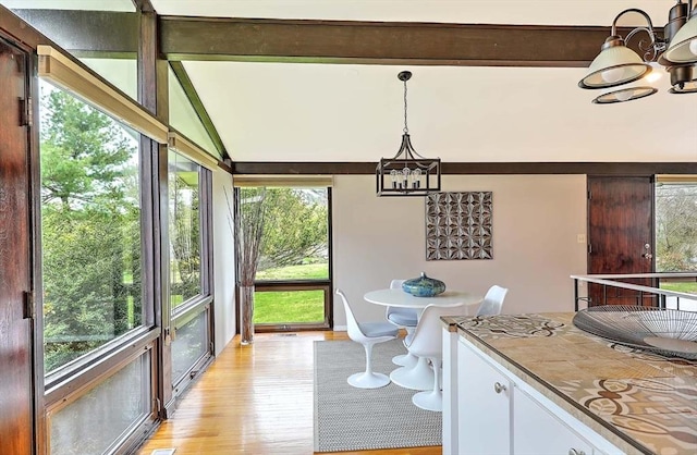 622 Pike Ave, Attleboro, MA 02703 - dining room with lofted ceiling with beams, a wealth of natural light, a chandelier, and light wood-type flooring