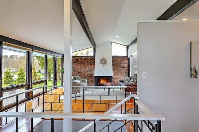 622 Pike Ave, Attleboro, MA 02703 - interior space featuring lofted ceiling with beams, brick wall, wood finished floors, and a fireplace