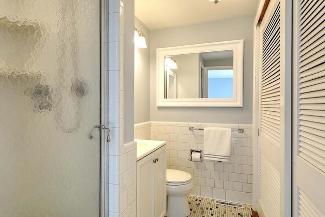 622 Pike Ave, Attleboro, MA 02703 - bathroom featuring a stall shower, toilet, tile walls, vanity, and wainscoting
