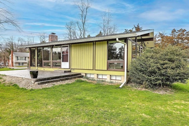 622 Pike Ave, Attleboro, MA 02703 - back of property featuring a lawn, a patio, and a chimney