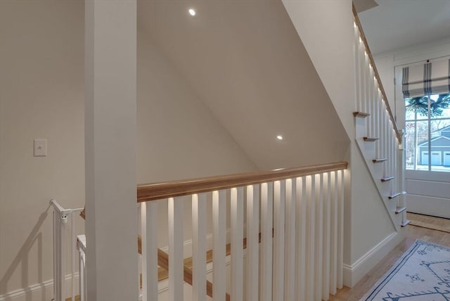 stairs featuring wood finished floors and baseboards