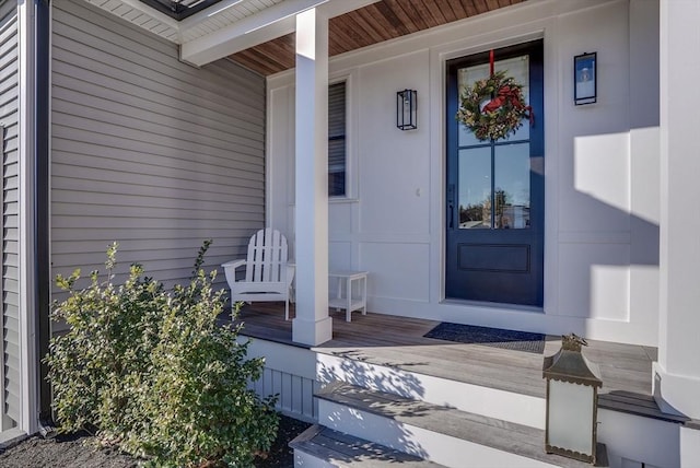 view of exterior entry featuring covered porch